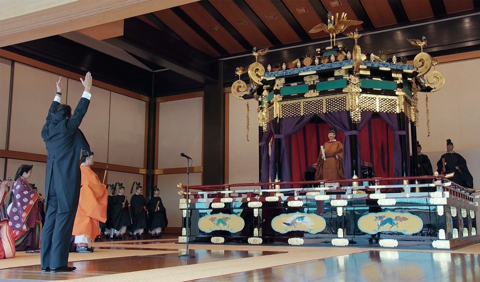 Japan’s Prime Minister Shinzo Abe, left, leads three “banzai” cheers for Emperor Naruhito as he proclaimed his ascension to the Chrysanthemum Throne