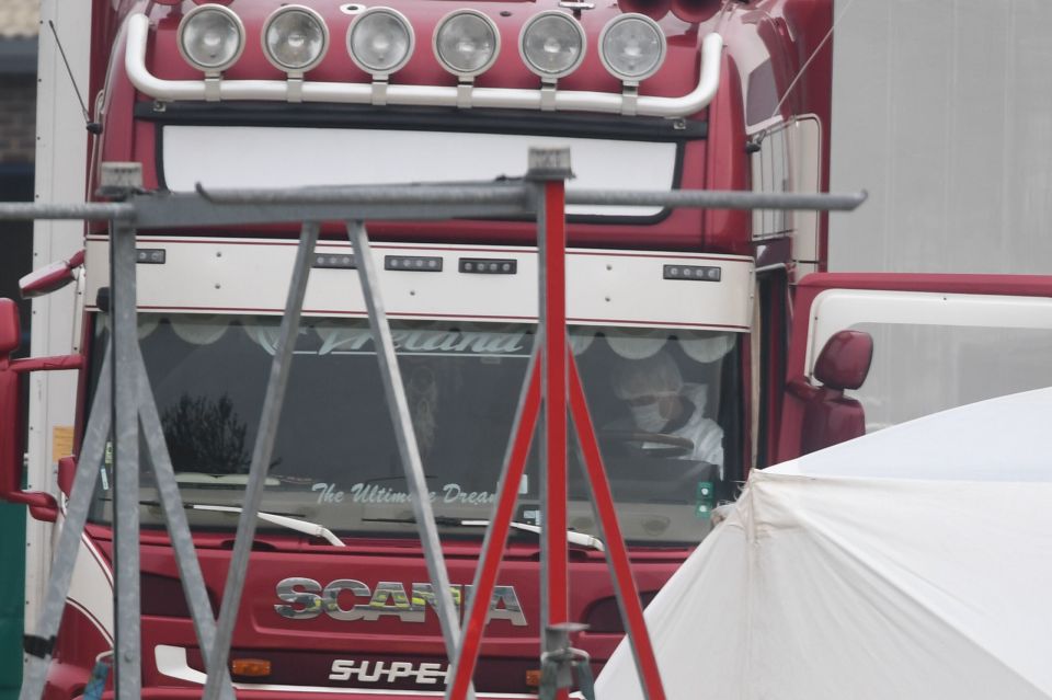  A forensic officer is seen inside the cab of the lorry in Essex today