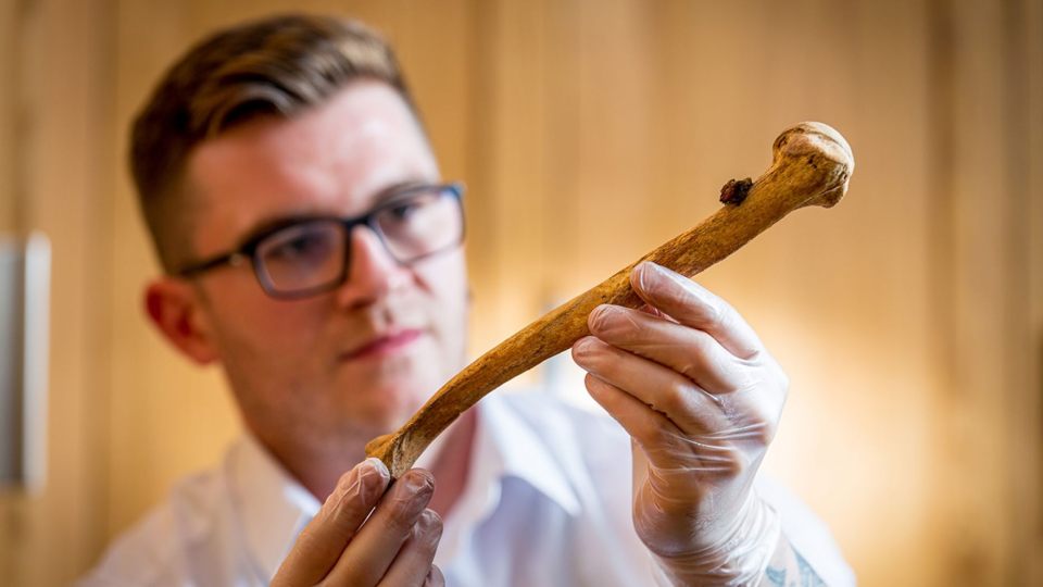  Historic Buildings Curator Alfred Hawkins with one of the bones, which were unearthed near a chapel at the Tower