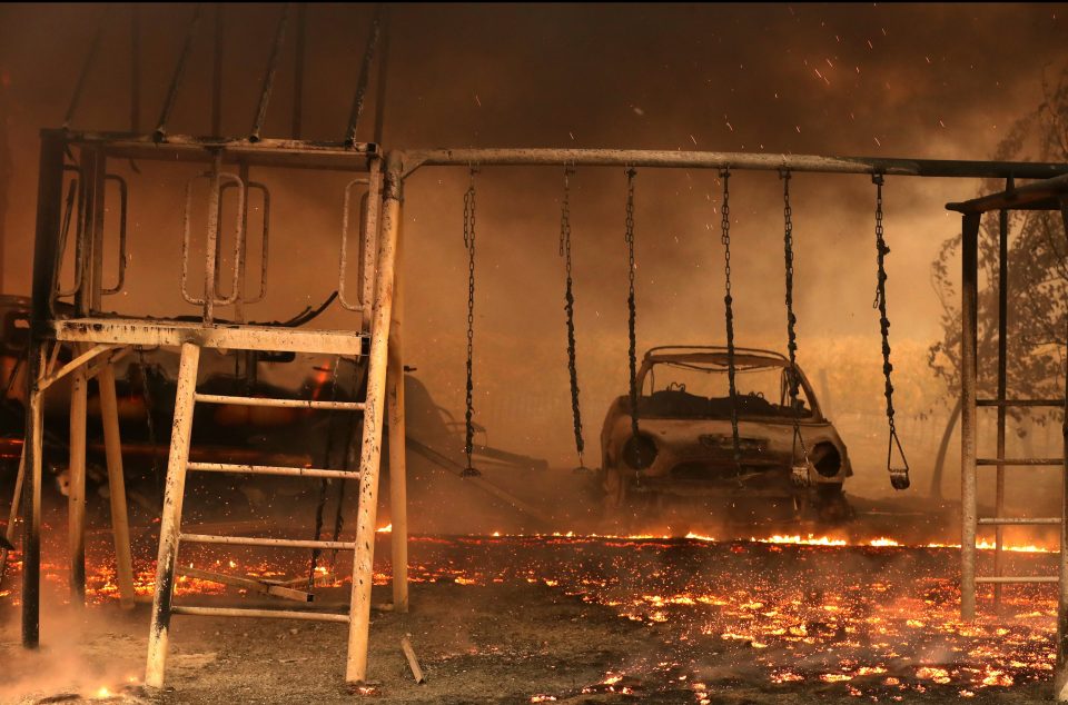  A burned car sits next to a swing after the Kincade Fire moves through Geyserville