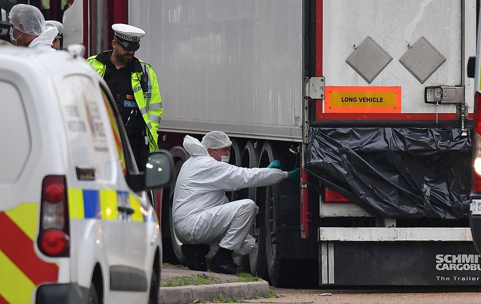  Forensics officers work on the lorry after the migrants' bodies were discovered in Grays, Essex