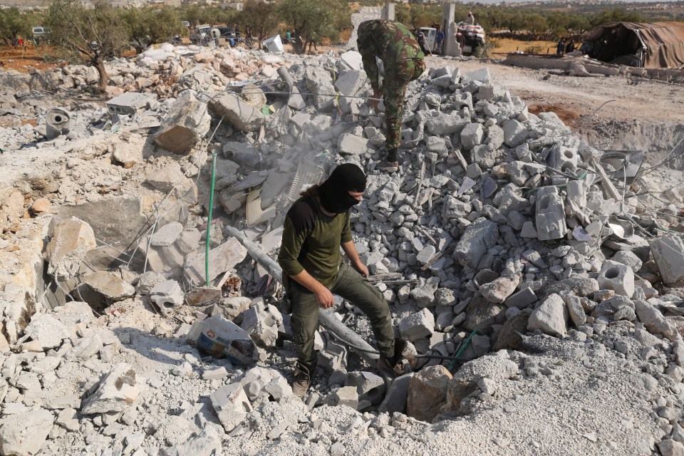  The remaining rubble of where his house stood is inspected after Baghdadi's death