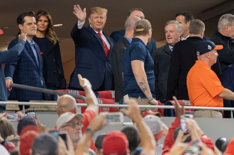  Trump appeared unfazed to the sounds of heckling and continued waving - even giving a thumbs-up