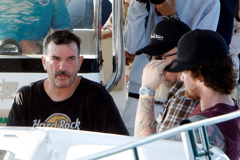  Amelia's dad Phil, left, on a search boat with other family members