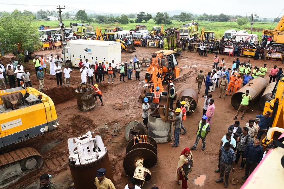  Rescue workers use heavy digging equipment during an operation to rescue a toddler stuck in a deep well in India