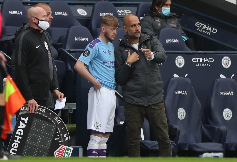  Pep Guardiola gives Tommy Doyle his instructions before he makes his debut