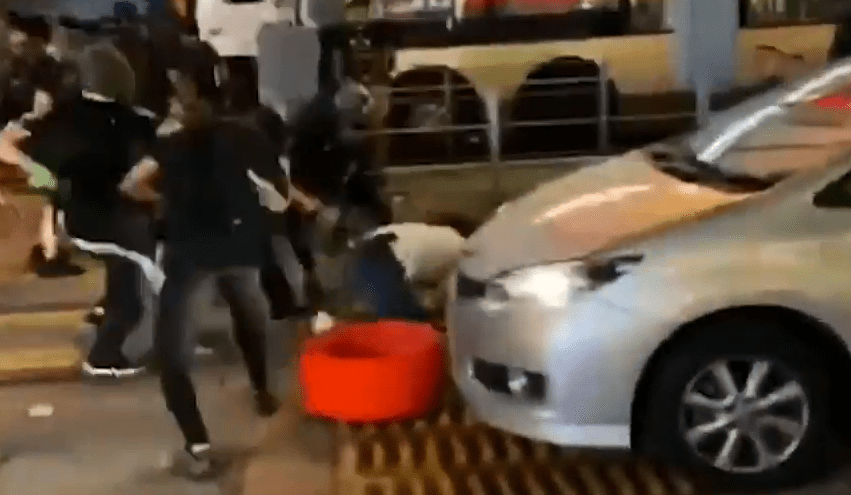  Protesters drag him from his car