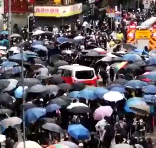  Moments before the taxi can be seen ploughing through a crowd of protesters