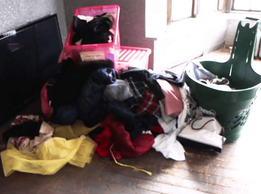  Rubbish, including a huge TV, was stacked up at the bottom of the stairs