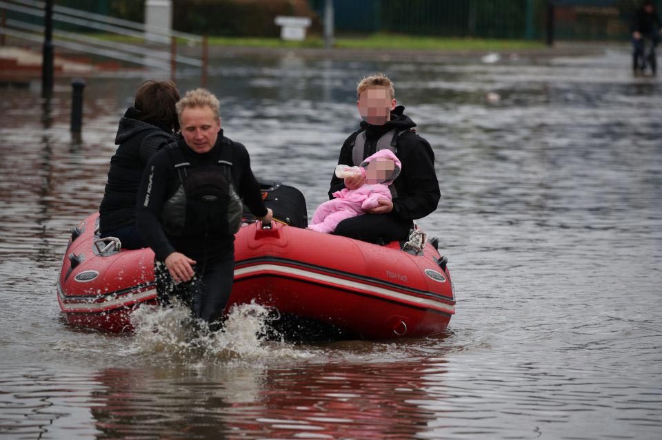  UK flooding: Kids are brought to safety by boat in the devastating floods