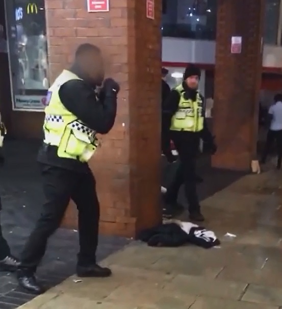  The guard is seen raising his hands in preparation for a fight after kicking the man