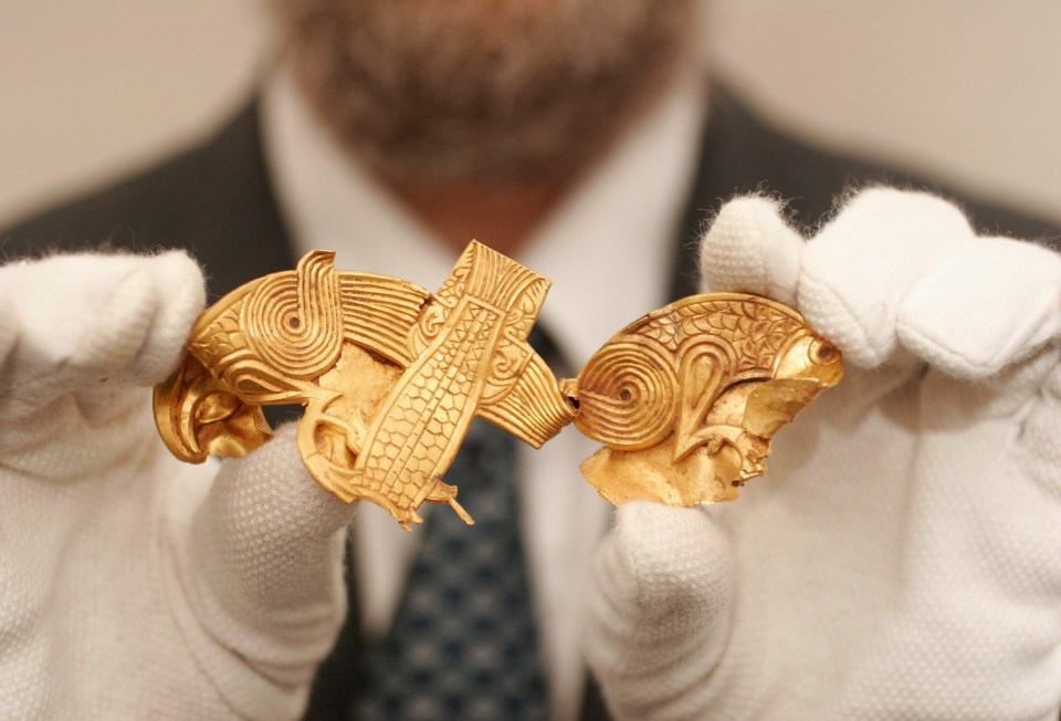 A gold plate with two eagles separated by fish in the Staffordshire hoard