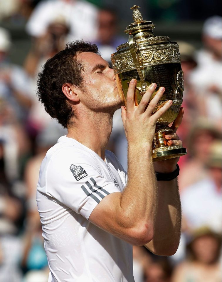  Andy Murray kisses the Wimbledon trophy after his 2013 win