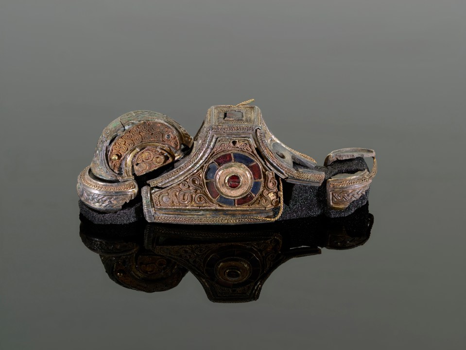 A sword pommel which was reconstructed from metal fragments found