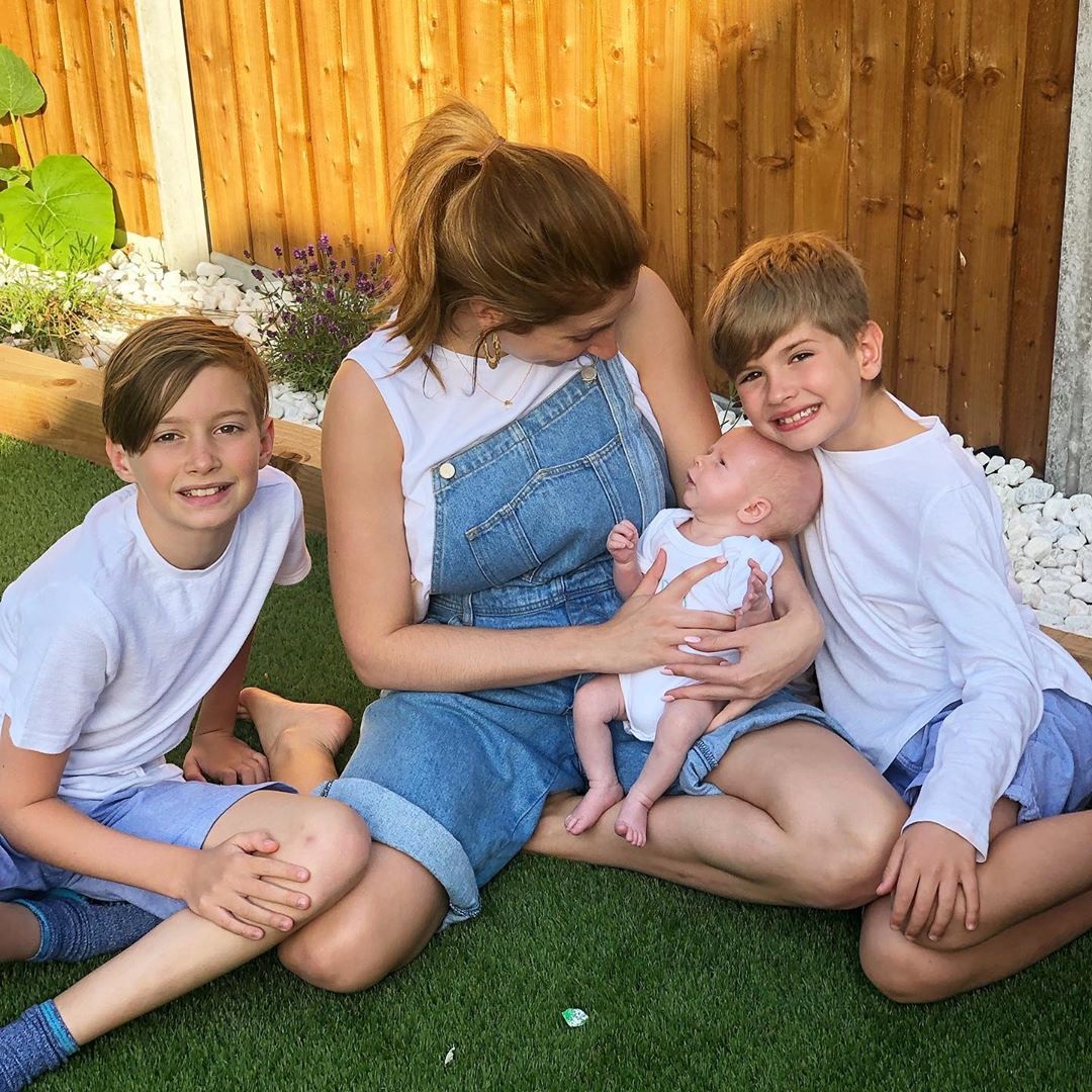 The family snuggle up for a group shot in the garden