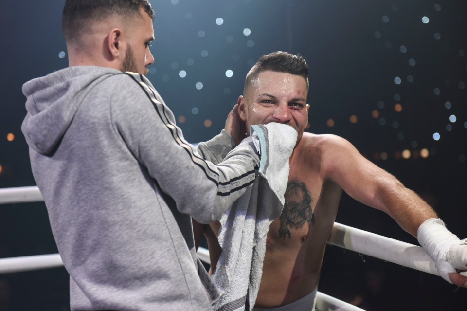  One brawler raises a smile as his cornerman wipes blood from his mouth