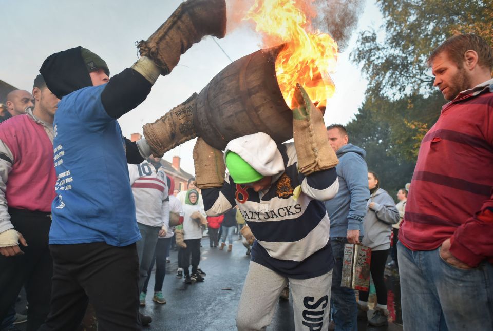  Children from the village of Ottery St Mary in Devon carry traditional burning tar barrels through the streets