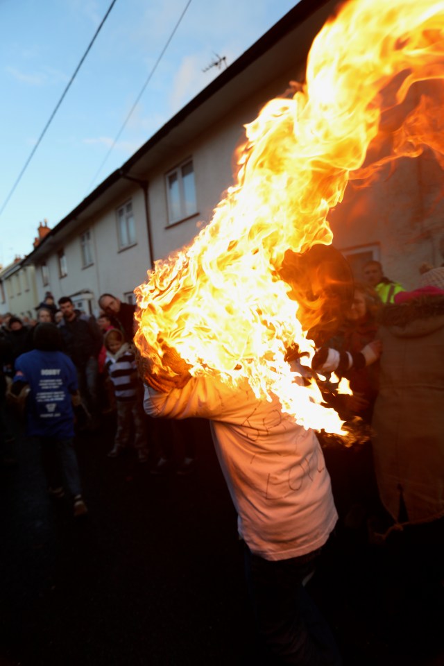  The 'barrel rollers' run around in the street carrying them on their backs with flames pouring out of the barrel