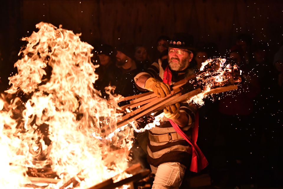  Revellers' torches are thrown into the fire after being paraded through the streets of Lewes