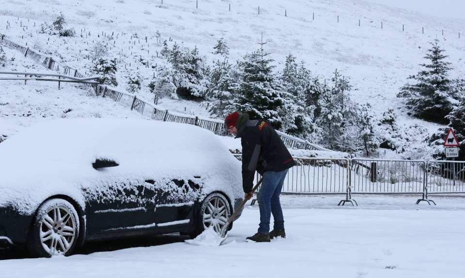  Commuter Neil Robb had to clear snow from around his car first thing this morning in the Scottish village of Tomintoul