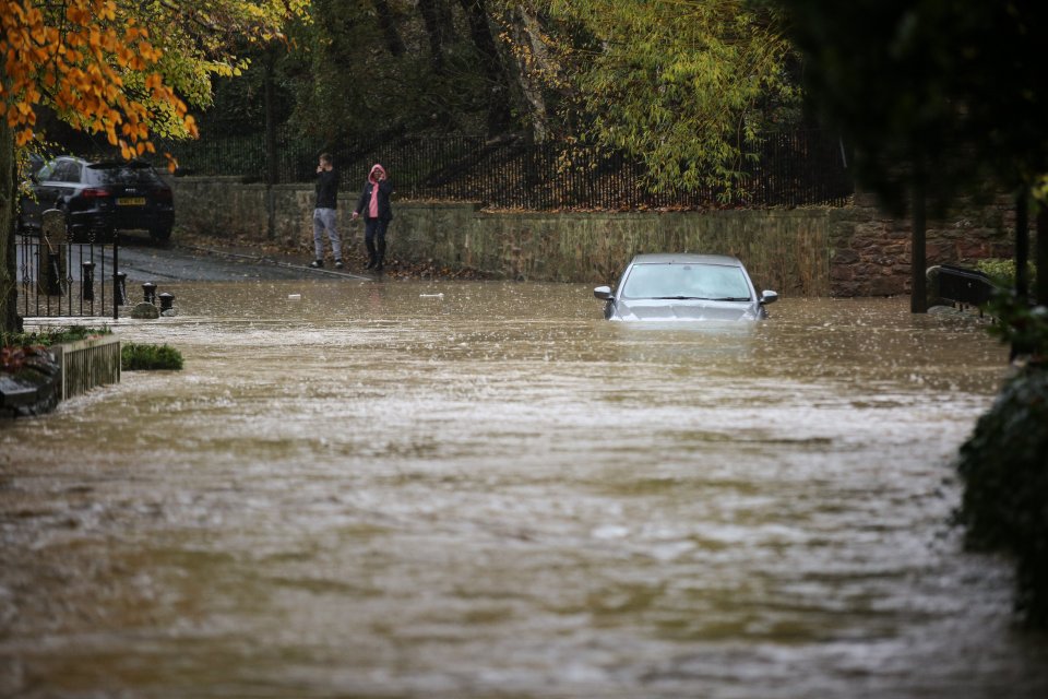  A car is stuck in the flooding in the village of Whiston near Sheffield