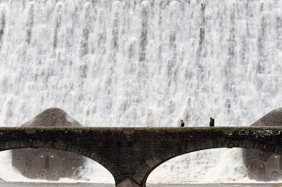  Water cascades over the Caban Coch Dam in Elan Valley, near Rhayader in Powys