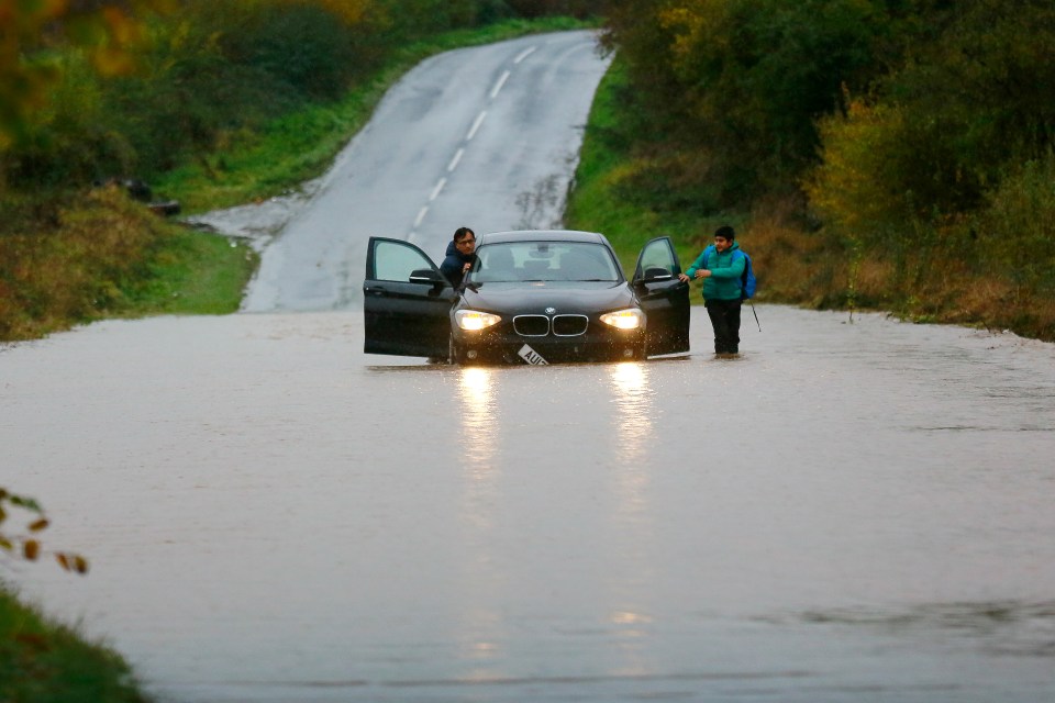  This family's car got stuck in the floods as rain hit large parts of northern England