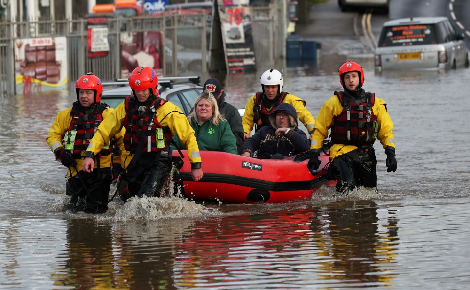  People are ferried to safety through the floodwaters in Rotherham