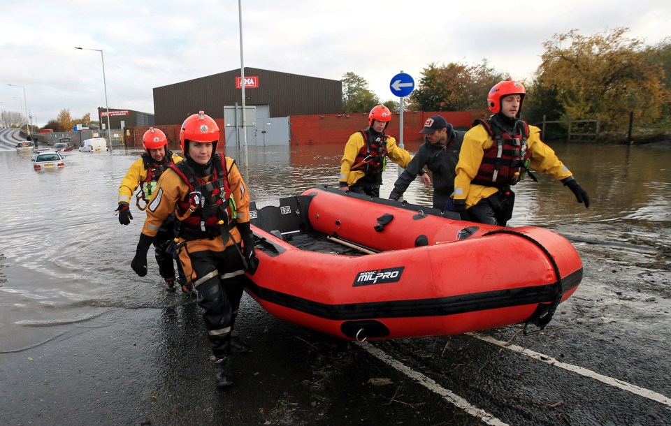  Rescuers head towards cars trapped in Rotherham after torrential rain caused flooding