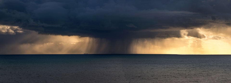  A huge cloud dumps rain near a ship off Bridport in Dorset yesterday