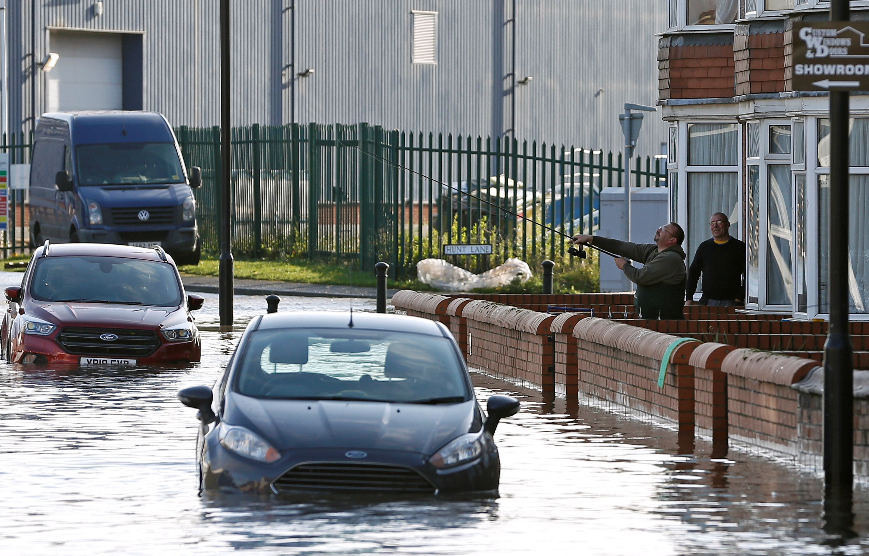  One man casts his fishing rod over a flooded street north of Doncaster