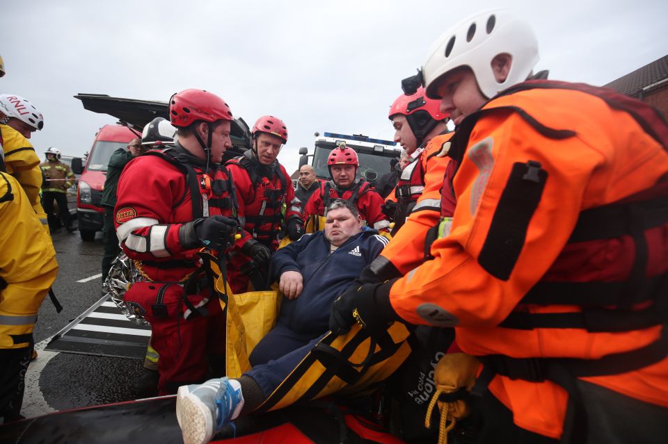  Another resident is hauled to safety by heroic rescue workers in Doncaster