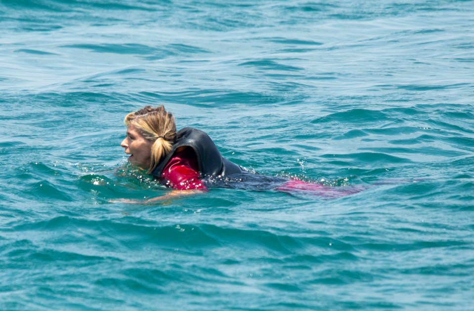 Kate, who was dressed in a playsuit, paddled ashore in her life jacket