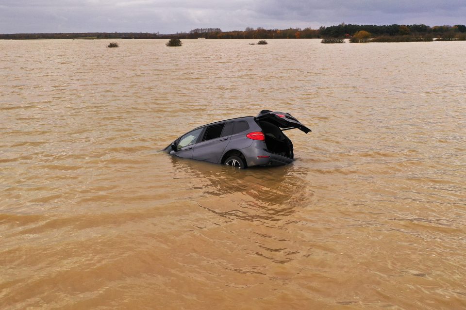  A car is seen part submerged in floodwater at Bardney, near Lincoln, after the Barlings Eau burst its banks