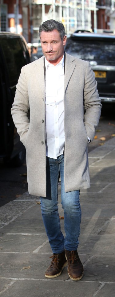 Former EastEnders star Dean looked relaxed in a grey coat