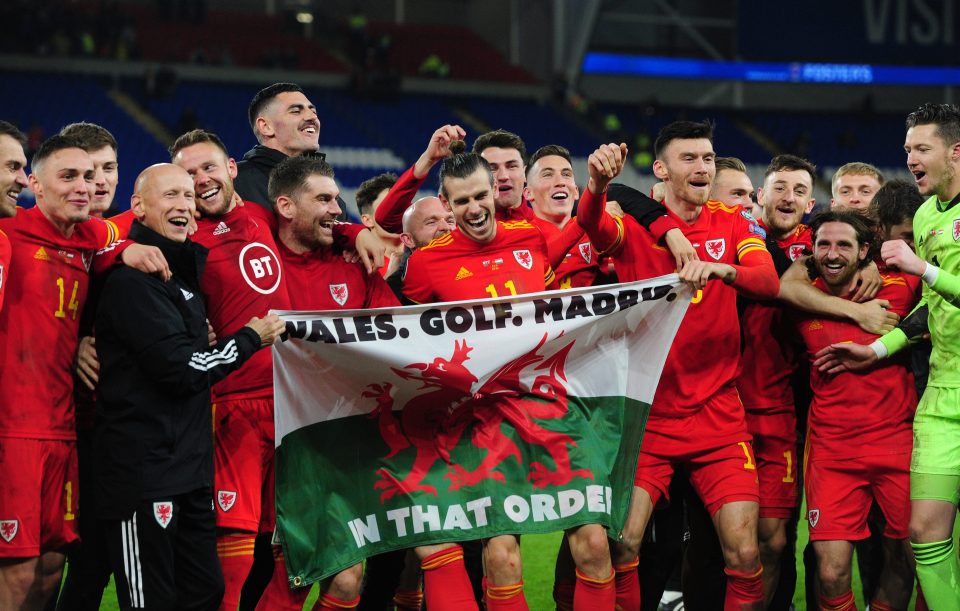  Gareth Bale holds a flag with the slogan: 'Wales. Golf. Madrid. In That Order'