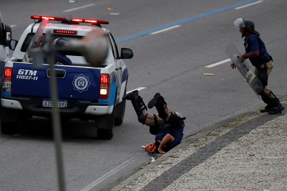  A police officer was hit at speed by a reversing police truck amid the chaos