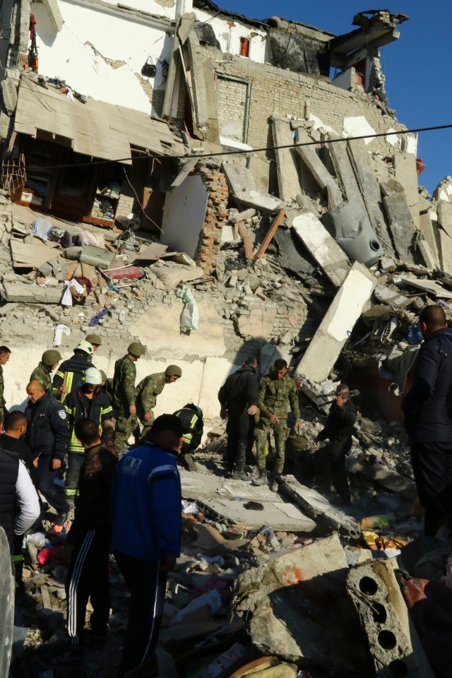  Rescuers search for survivors in a building damaged in a magnitude 6.4 earthquake in western Albania