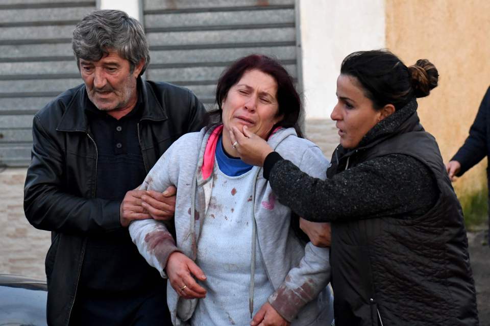  Relatives of people living at a collapsed building cry in Thumane, Albania