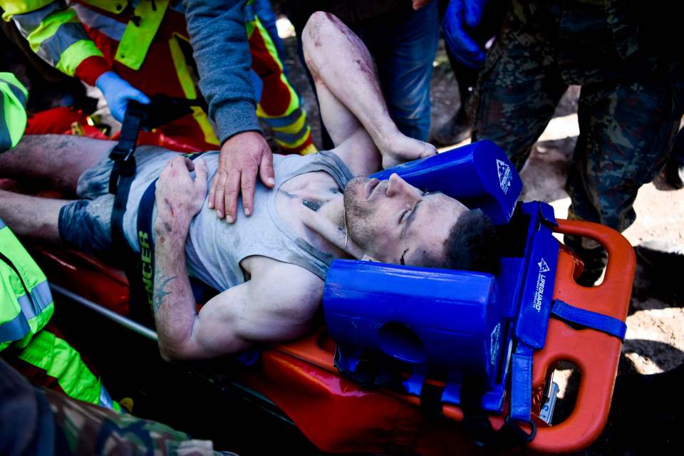  Rescuers carry Perparim Greku, 28, who survived the quake in Albania