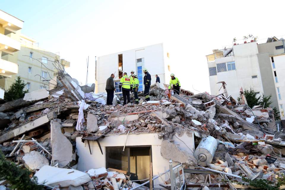  Emergency workers look for survivors buried in the debris at a damaged building in the coastal city of Durres