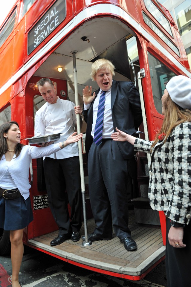  Rhodes with ex-London Mayor Boris Johnson at the back of a historic Routemaster bus in 2009