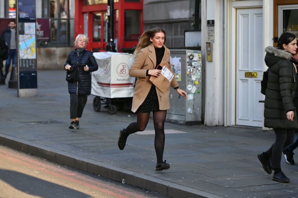  A woman can be seen running from London Bridge