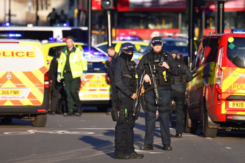  Armed police at the scene where two people were stabbed in a terror attack