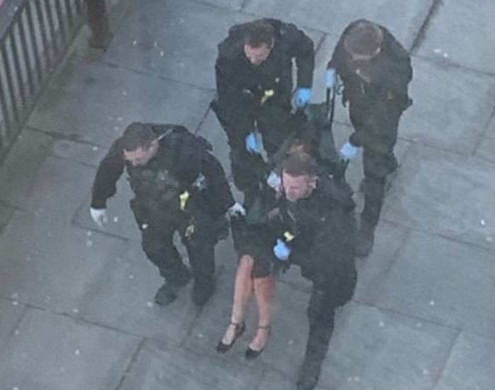  A woman can be seen being carried away from the London Bridge