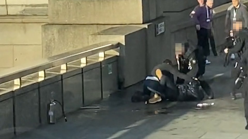  One of the passersby is seen wrestling the man to the ground and pinning him down on London Bridge