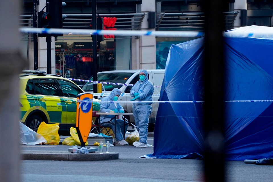 Forensics officers work outside a tent near London Bridge