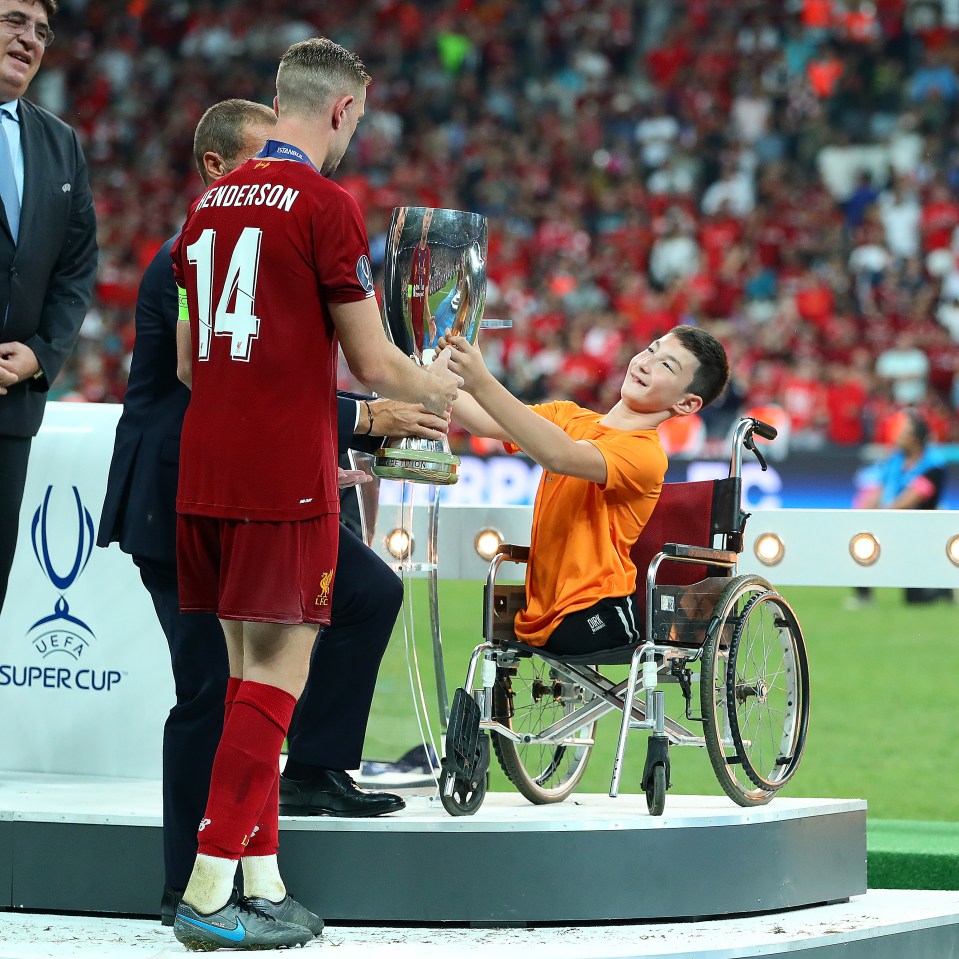  The youngster was also seen handing Jordan Henderson the UEFA Super Cup trophy