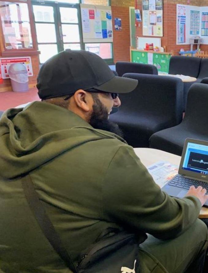  This image shows Usman Khan with a computer given to him through Learning Together