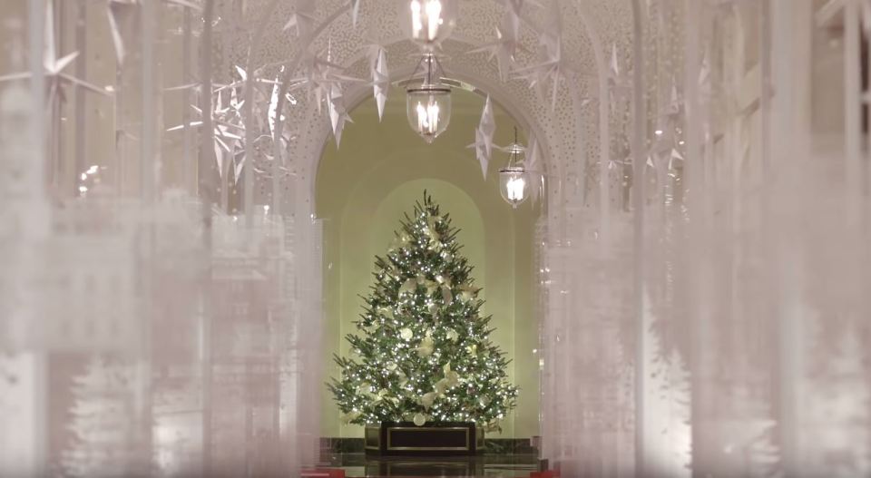  Clips from inside the residence show a hallway lined with white suspended snowflakes and adorned with large a Christmas tree